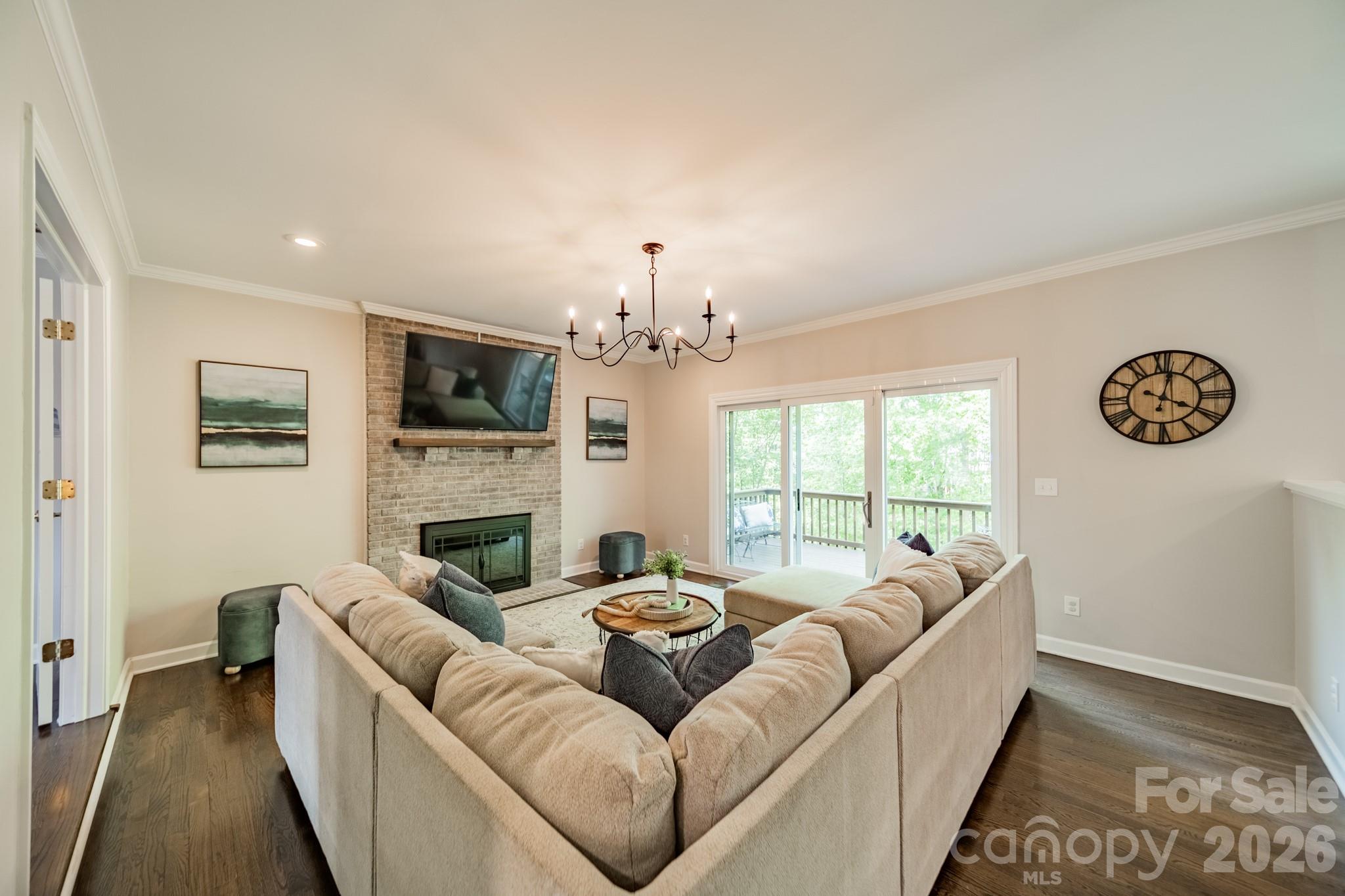 231 South Downs Way Fort Mill, SC 29708 - Photo 11 of 48 a living room with furniture a fireplace and a chandelier