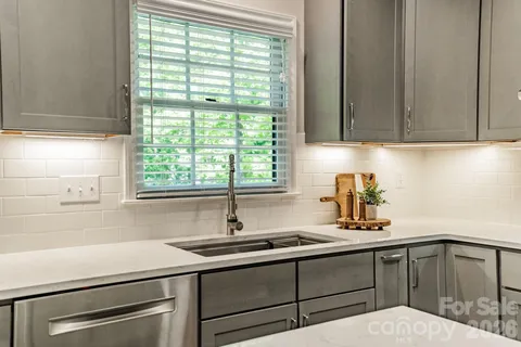 a kitchen with a sink cabinets and window