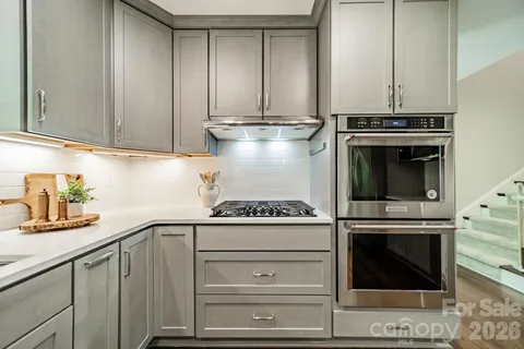 a stove top oven sitting inside of a kitchen