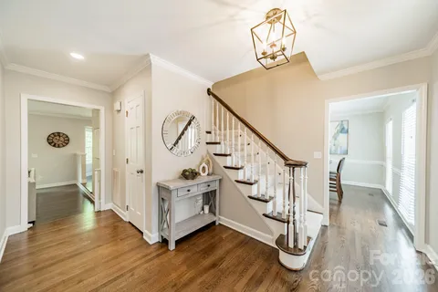 a view of entryway and hall with wooden floor