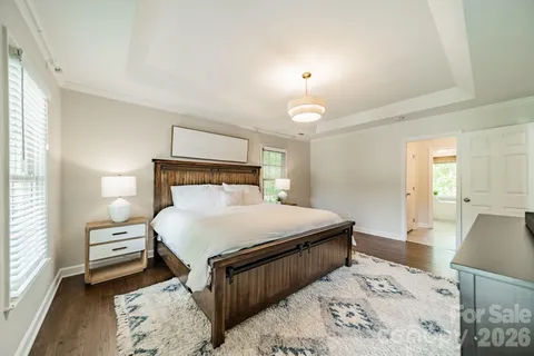 a bedroom with a bed and a lamp on dresser