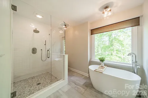 a bathroom with a tub and a shower