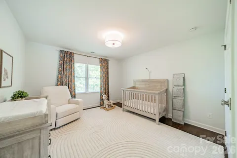 a bedroom with a white bed and white walls