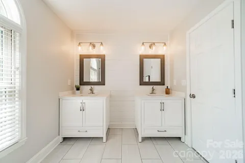 a bathroom with mirror a sink and a mirror