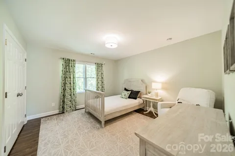 a bedroom with a bed and lamp