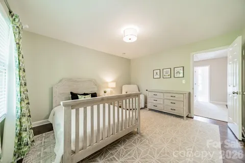 a view of a bedroom with furniture and windows