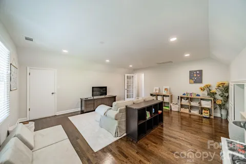 a living room with lots of furniture and kitchen view
