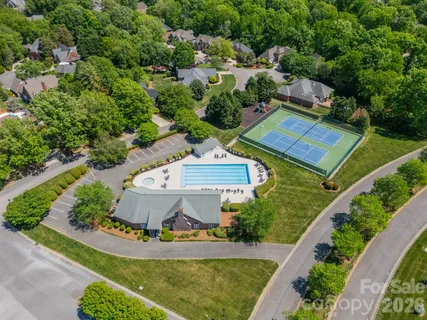 an aerial view of a house with a garden and lake view