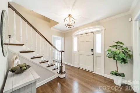 a view of entryway and hall with wooden floor