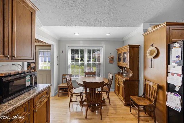 a view of a dining room with furniture and a window
