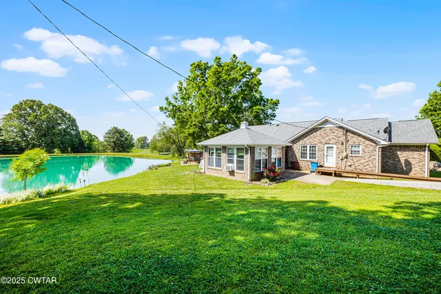 a front view of a house with swimming pool having outdoor seating
