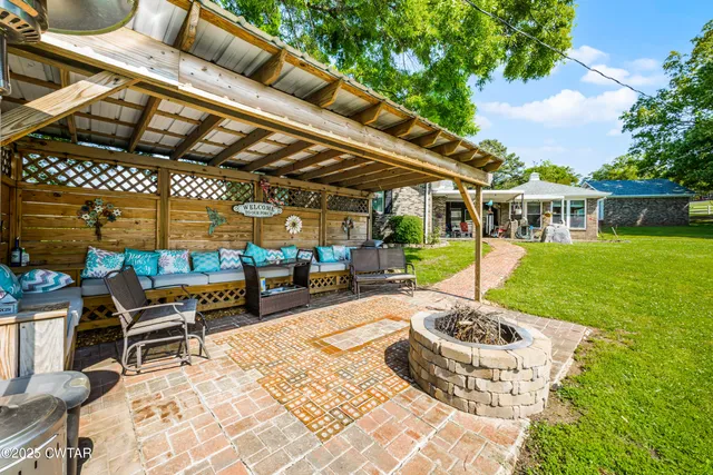 a view of a patio with a dining table and chairs with wooden floor