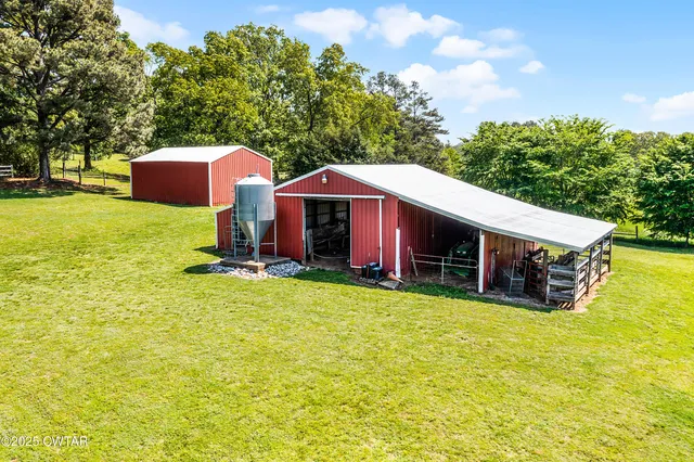 a view of a house with a yard and sitting area