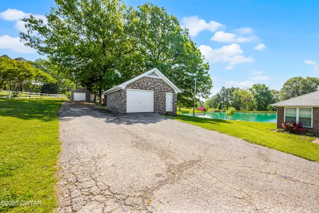 a view of a house with a yard and tree s