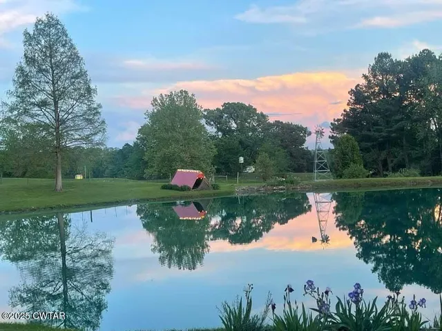 a view of a lake with a house in the background