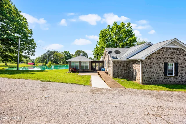 a view of a house with a swimming pool and yard