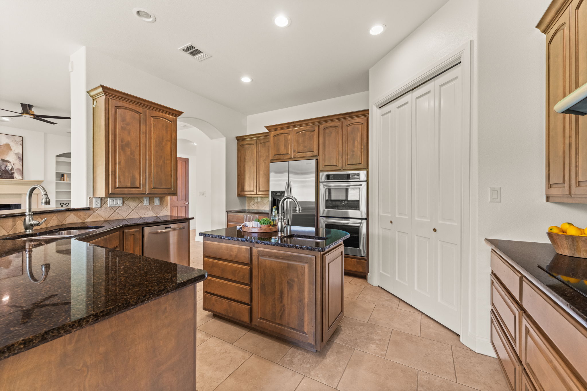 15 Borello Drive Austin, TX 78738 - Photo 11 of 36 a kitchen with stainless steel appliances granite countertop a stove a sink and a refrigerator