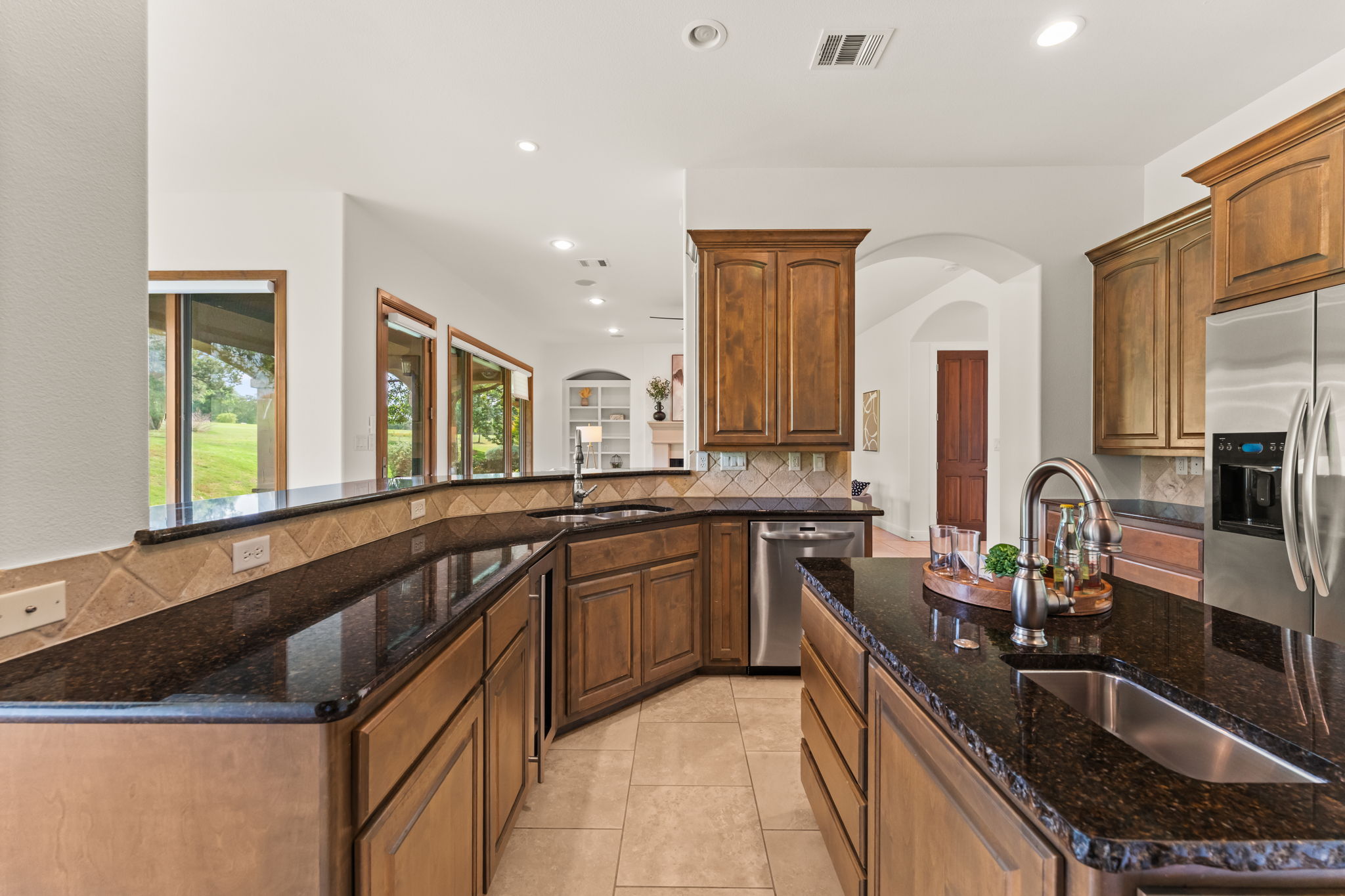 15 Borello Drive Austin, TX 78738 - Photo 14 of 36 a large kitchen with granite countertop a sink and cabinets