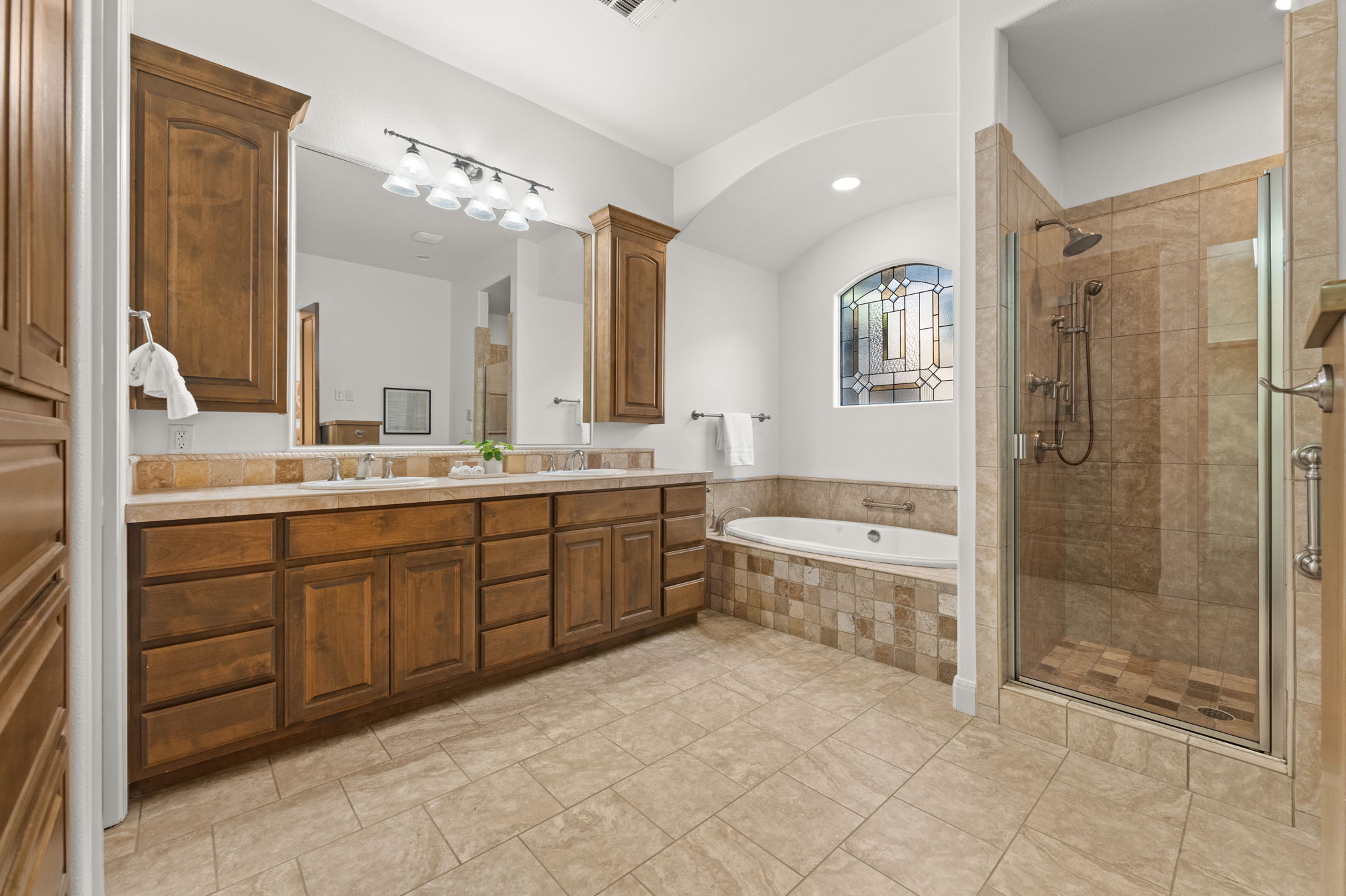15 Borello Drive Austin, TX 78738 - Photo 17 of 36 a spacious bathroom with a shower sink mirror and a bathtub