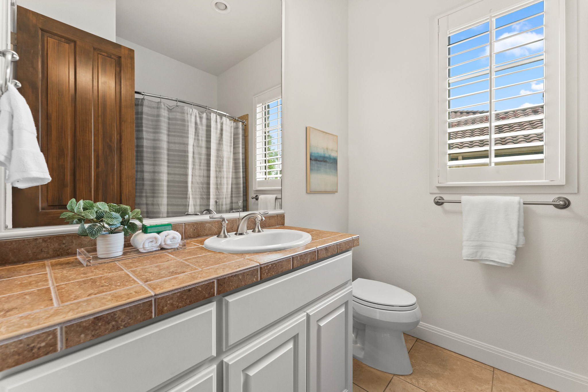 15 Borello Drive Austin, TX 78738 - Photo 19 of 36 a bathroom with a granite countertop sink and a mirror