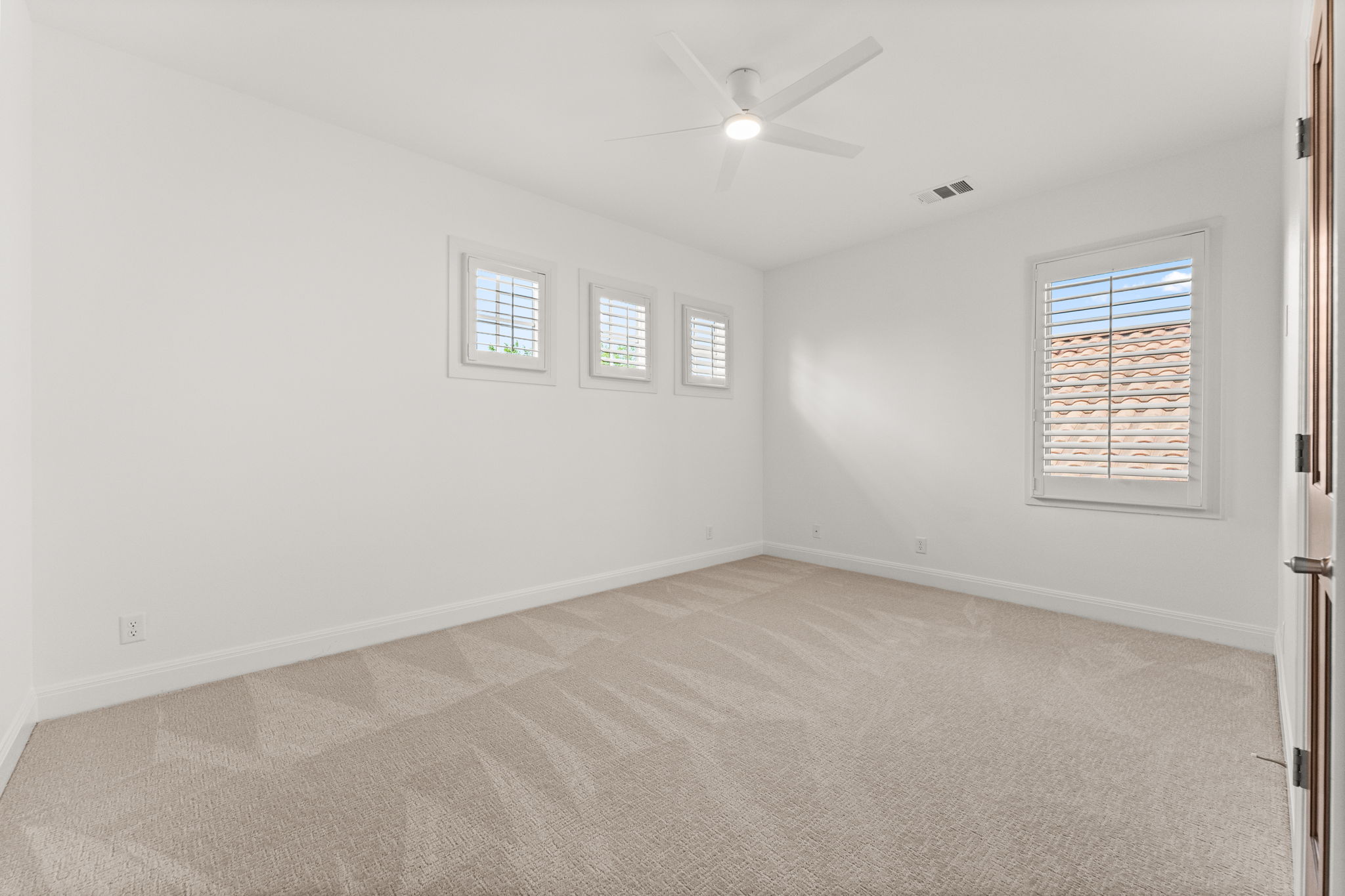 15 Borello Drive Austin, TX 78738 - Photo 24 of 36 an empty room with a window and a ceiling fan