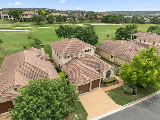 an aerial view of a house with garden space and ocean view