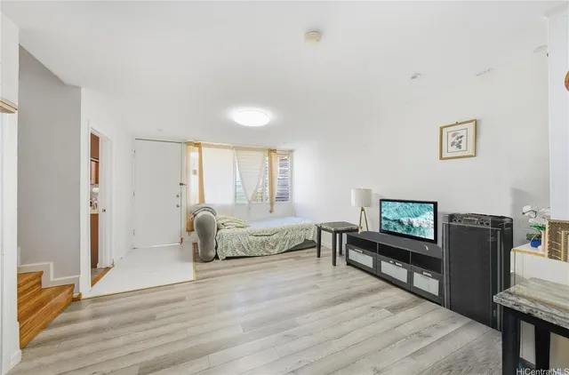 a bedroom with furniture and a flat screen tv