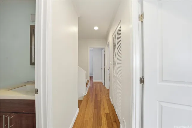 a view of hallway with wooden floor