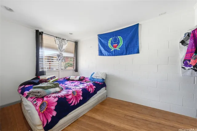 a bed sitting in a bedroom next to a window