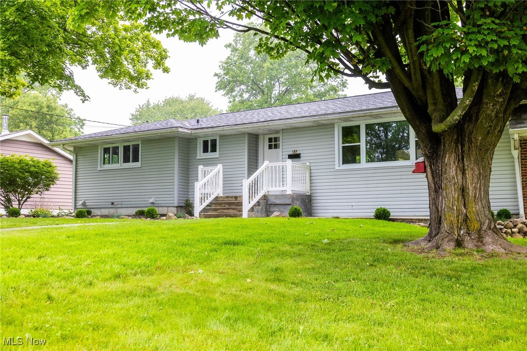 55 Elm Street Rittman, OH 44270 - Photo 5 of 46 Ranch-style home featuring a front yard and roof with shingles