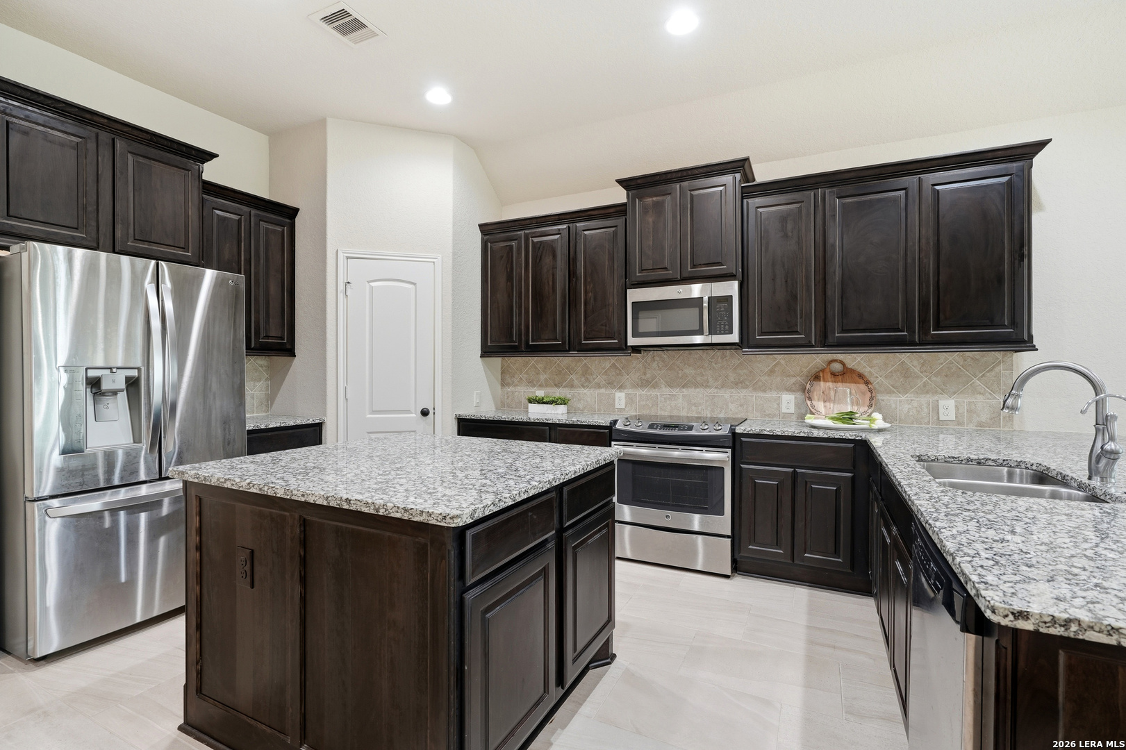 2129 Range Road Seguin, TX 78155 - Photo 11 of 41 a kitchen with granite countertop stainless steel appliances and wooden cabinets