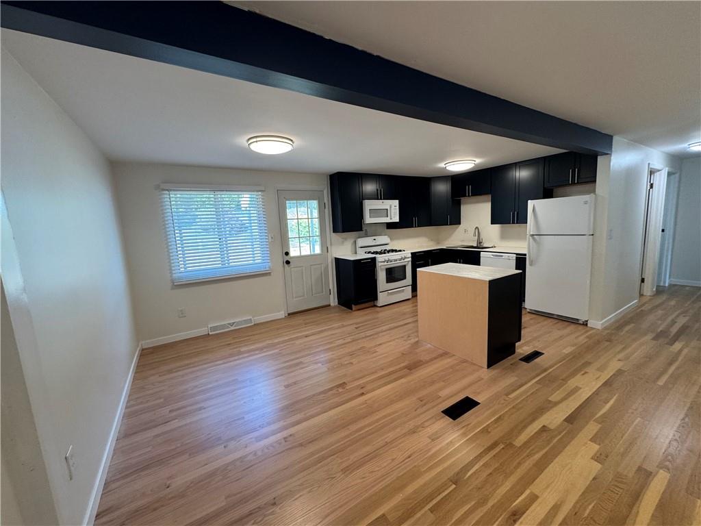 111 Tree View Drive Coraopolis, PA 15108 - Photo 14 of 29 a open kitchen with a sink dishwasher a refrigerator and wooden cabinets with wooden floor