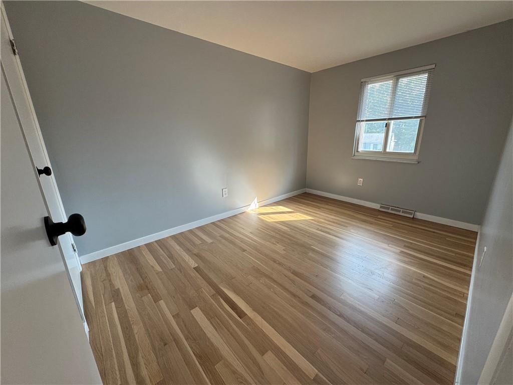 111 Tree View Drive Coraopolis, PA 15108 - Photo 21 of 29 wooden floor in an empty room with a window