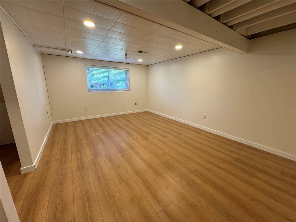 111 Tree View Drive Coraopolis, PA 15108 - Photo 25 of 29 an empty room with wooden floor and windows