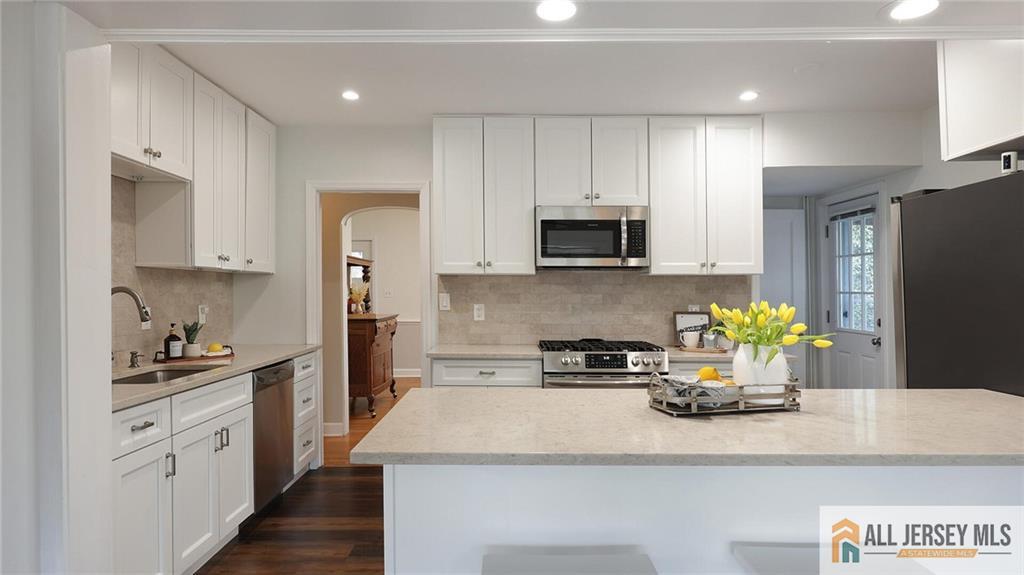 333 Melrose Avenue Middlesex, NJ 08846 - Photo 11 of 36 a kitchen with a sink a stove and cabinets
