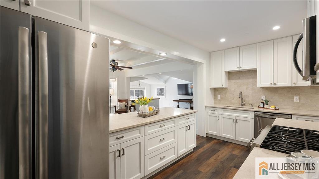 333 Melrose Avenue Middlesex, NJ 08846 - Photo 12 of 36 a kitchen with white cabinets and appliances