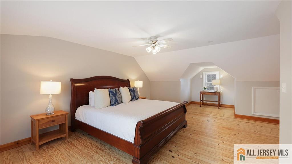 333 Melrose Avenue Middlesex, NJ 08846 - Photo 24 of 36 a bedroom with a bed and a chandelier