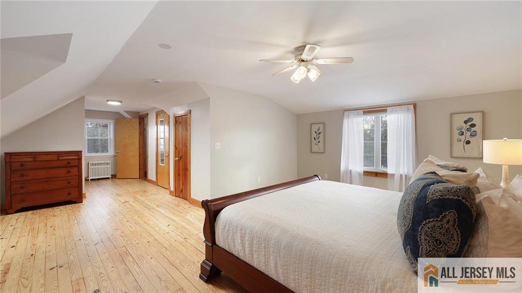 333 Melrose Avenue Middlesex, NJ 08846 - Photo 25 of 36 a spacious bedroom with a bed and a chandelier