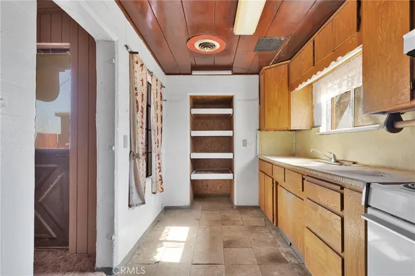 a kitchen with a sink cabinets and a window