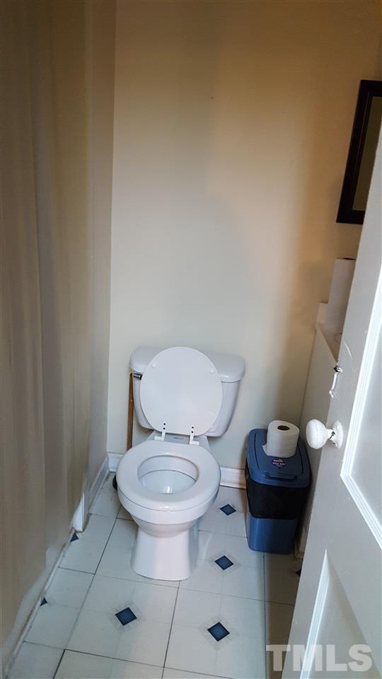 801 Coleman Street Raleigh, NC 27610 - Photo 8 of 12 a white toilet sitting next to a bathroom sink