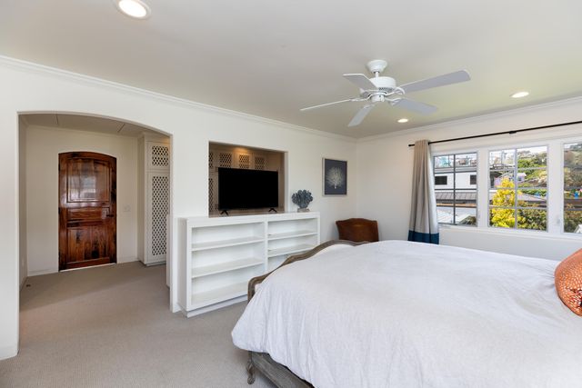 a bedroom with furniture and a flat screen tv