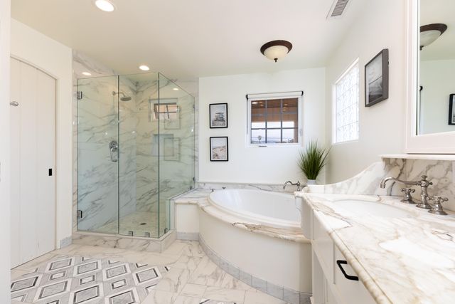 a spacious bedroom with a bed and cabinet