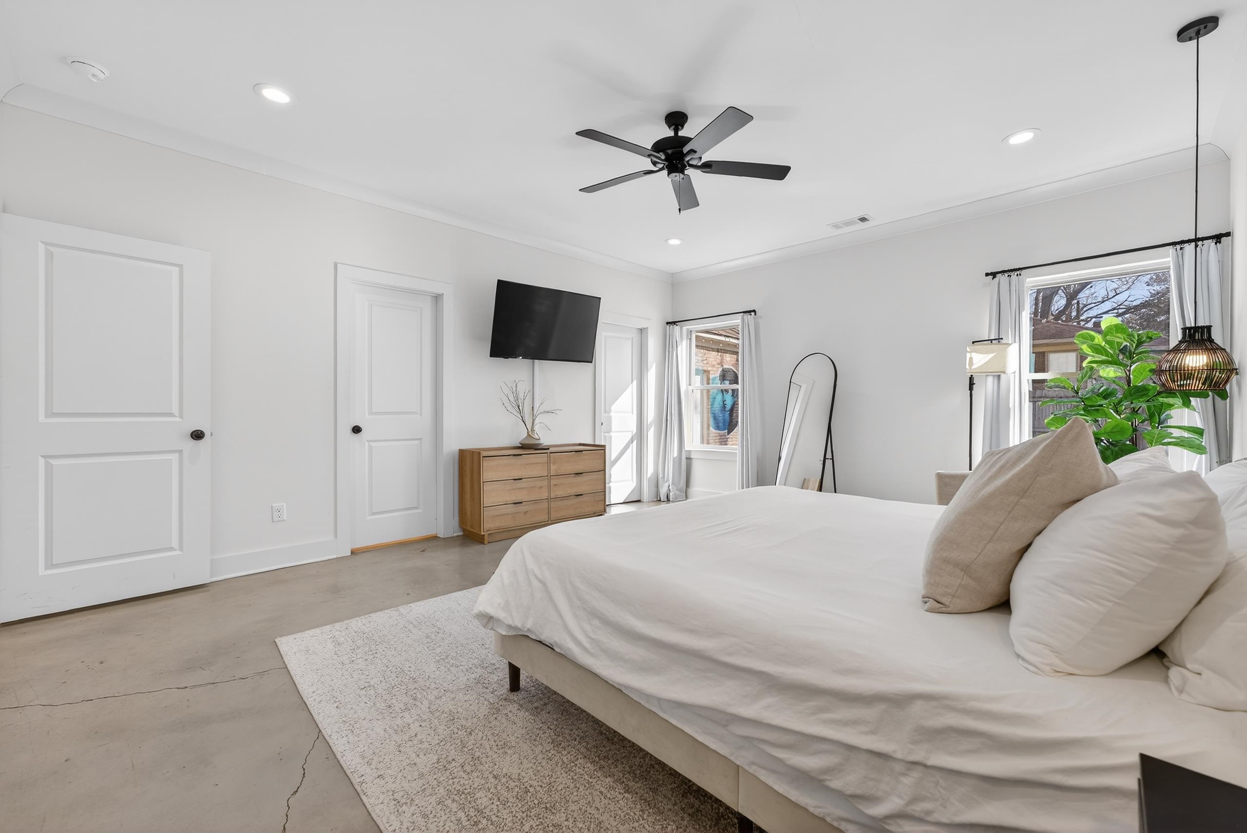 668 Hawthorne Street Memphis, TN 38107 - Photo 12 of 24 Bedroom with finished concrete floors, multiple windows, a ceiling fan, recessed lighting, and ornamental molding