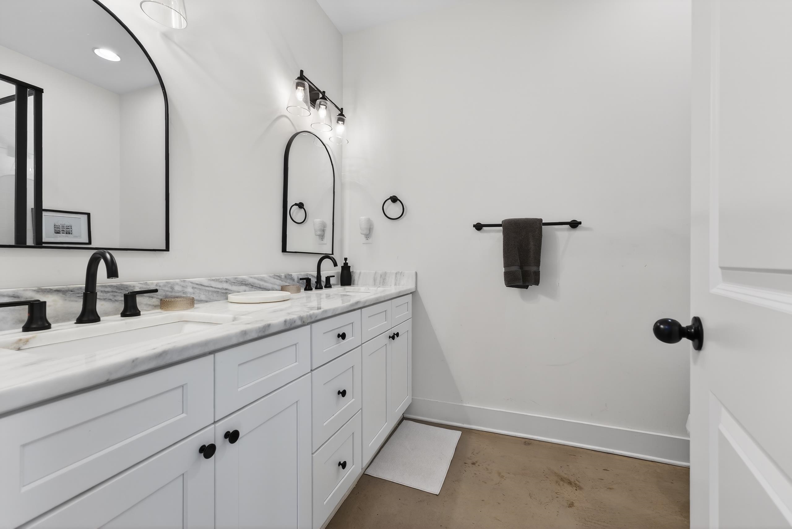 668 Hawthorne Street Memphis, TN 38107 - Photo 15 of 24 Full bathroom featuring double vanity and unfinished concrete flooring