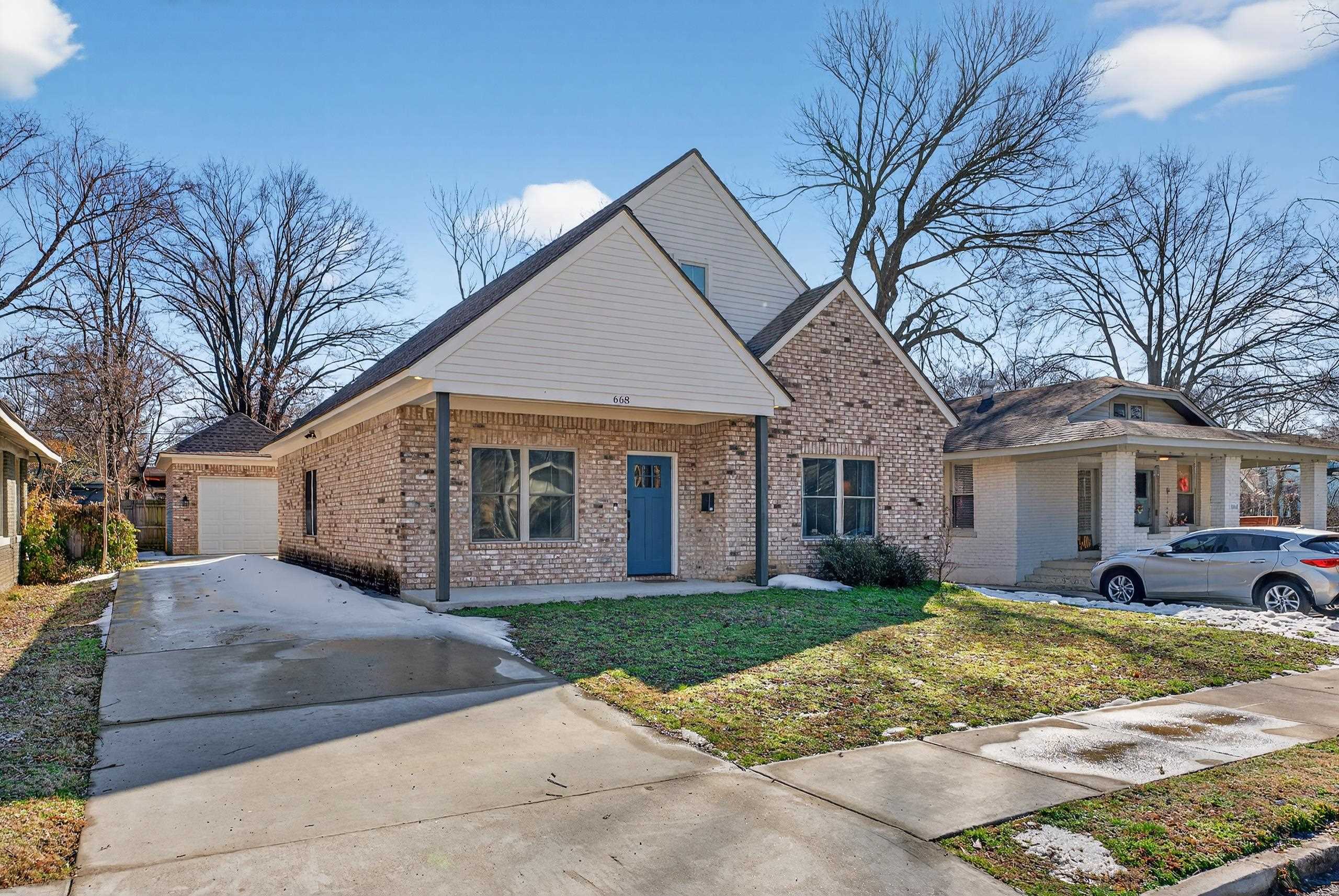 668 Hawthorne Street Memphis, TN 38107 - Photo 2 of 24 View of front of house with brick siding, driveway, covered porch, and a front lawn