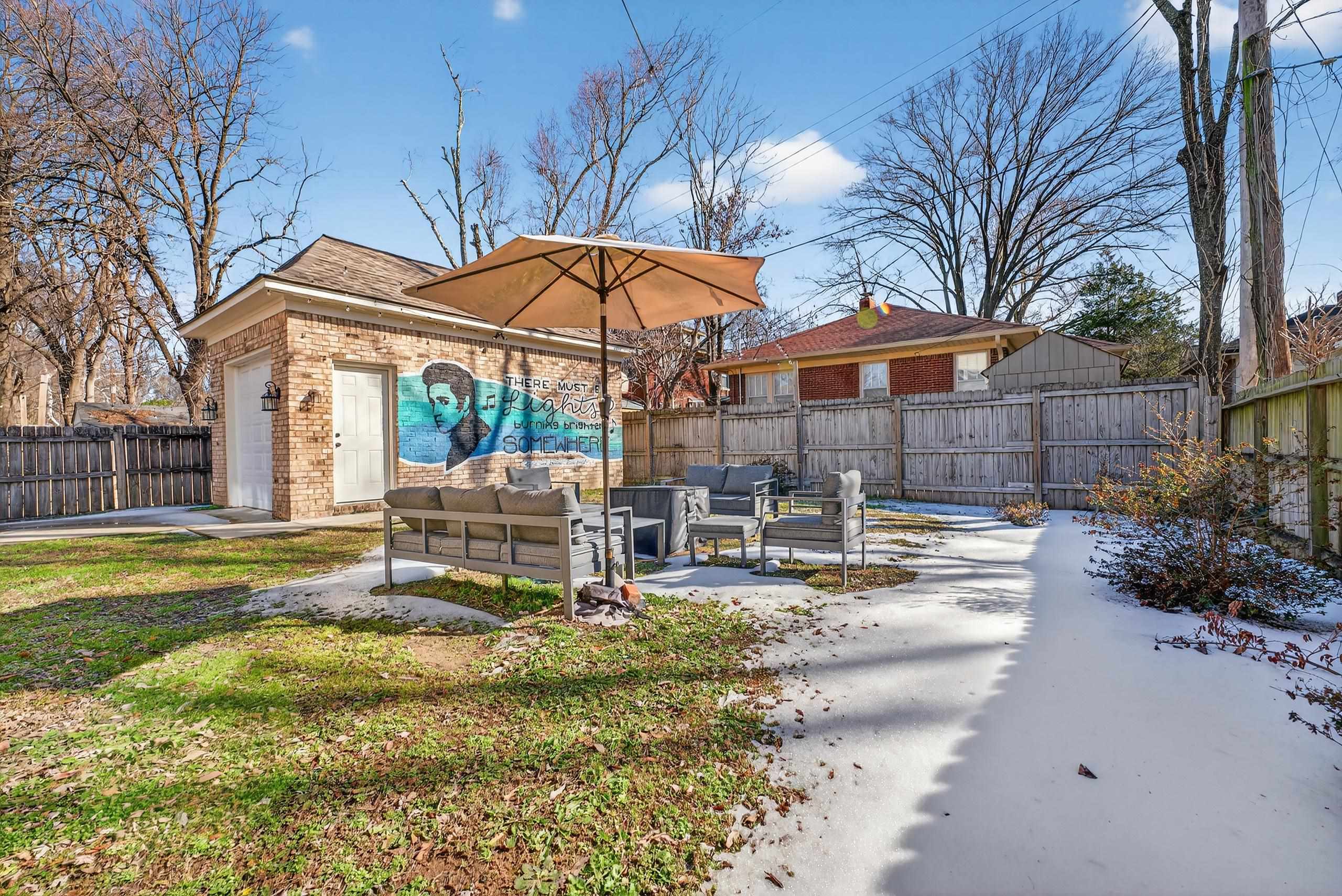 668 Hawthorne Street Memphis, TN 38107 - Photo 3 of 24 Fenced backyard featuring an outdoor structure, outdoor lounge area, and a patio area