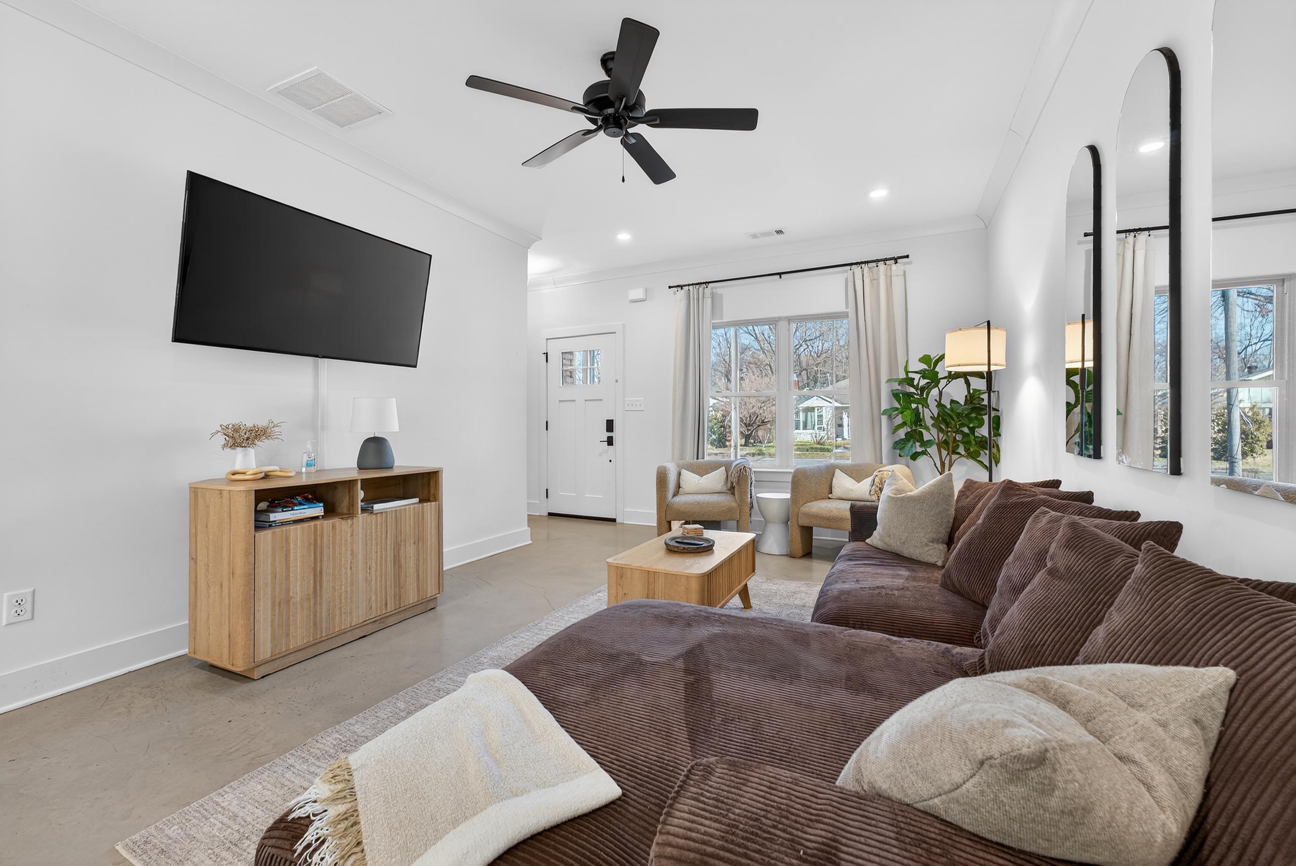 668 Hawthorne Street Memphis, TN 38107 - Photo 7 of 24 Living room with concrete floors, crown molding, ceiling fan, and recessed lighting