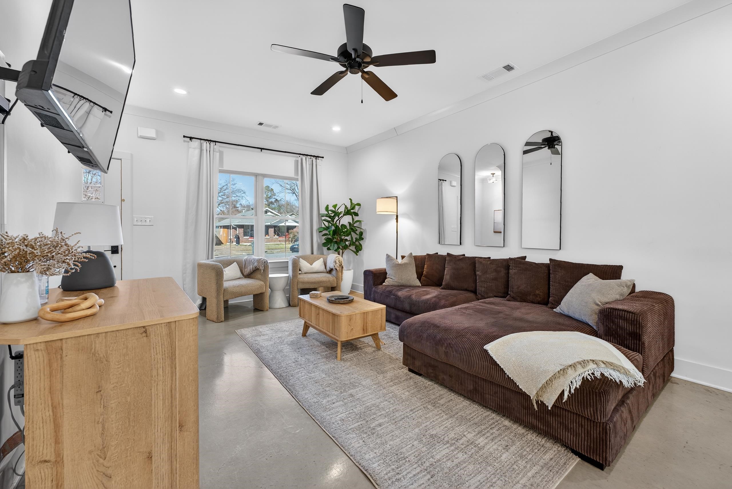 668 Hawthorne Street Memphis, TN 38107 - Photo 8 of 24 Living room with finished concrete floors, a ceiling fan, ornamental molding, and recessed lighting
