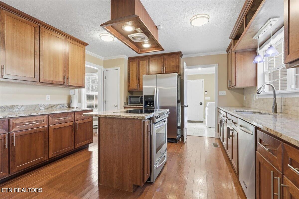 105 Carl Terry Road Wartburg, TN 37887 - Photo 13 of 55 a large kitchen with stainless steel appliances granite countertop a lot of counter space and wooden floors