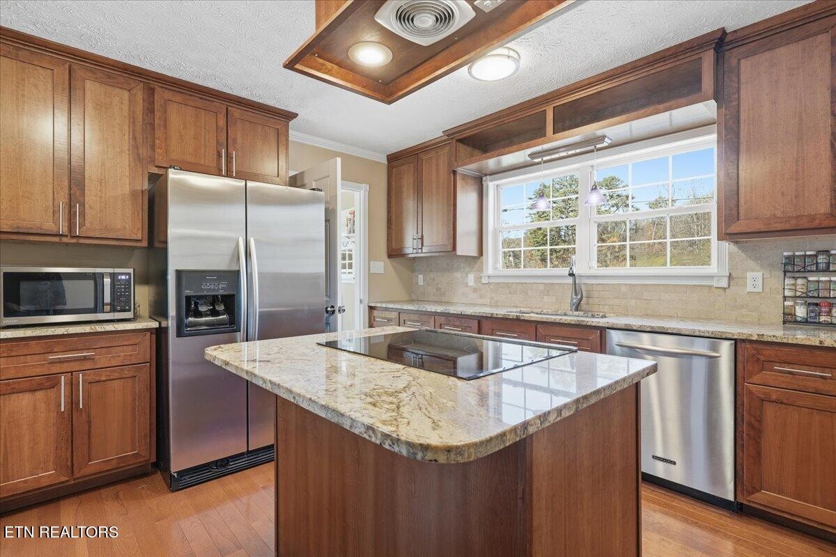 105 Carl Terry Road Wartburg, TN 37887 - Photo 16 of 55 a kitchen with stainless steel appliances granite countertop a sink stove microwave and refrigerator
